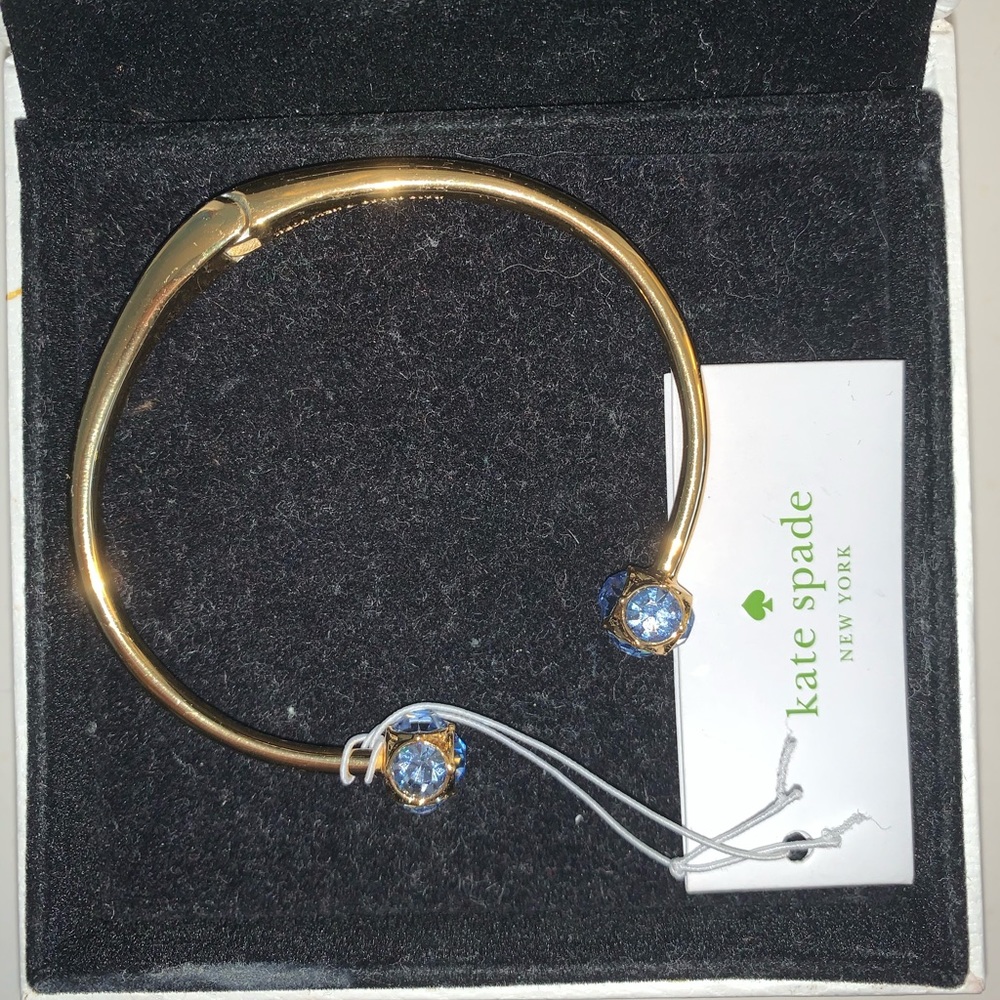 Gold Kate Spade cuff with blue crystals